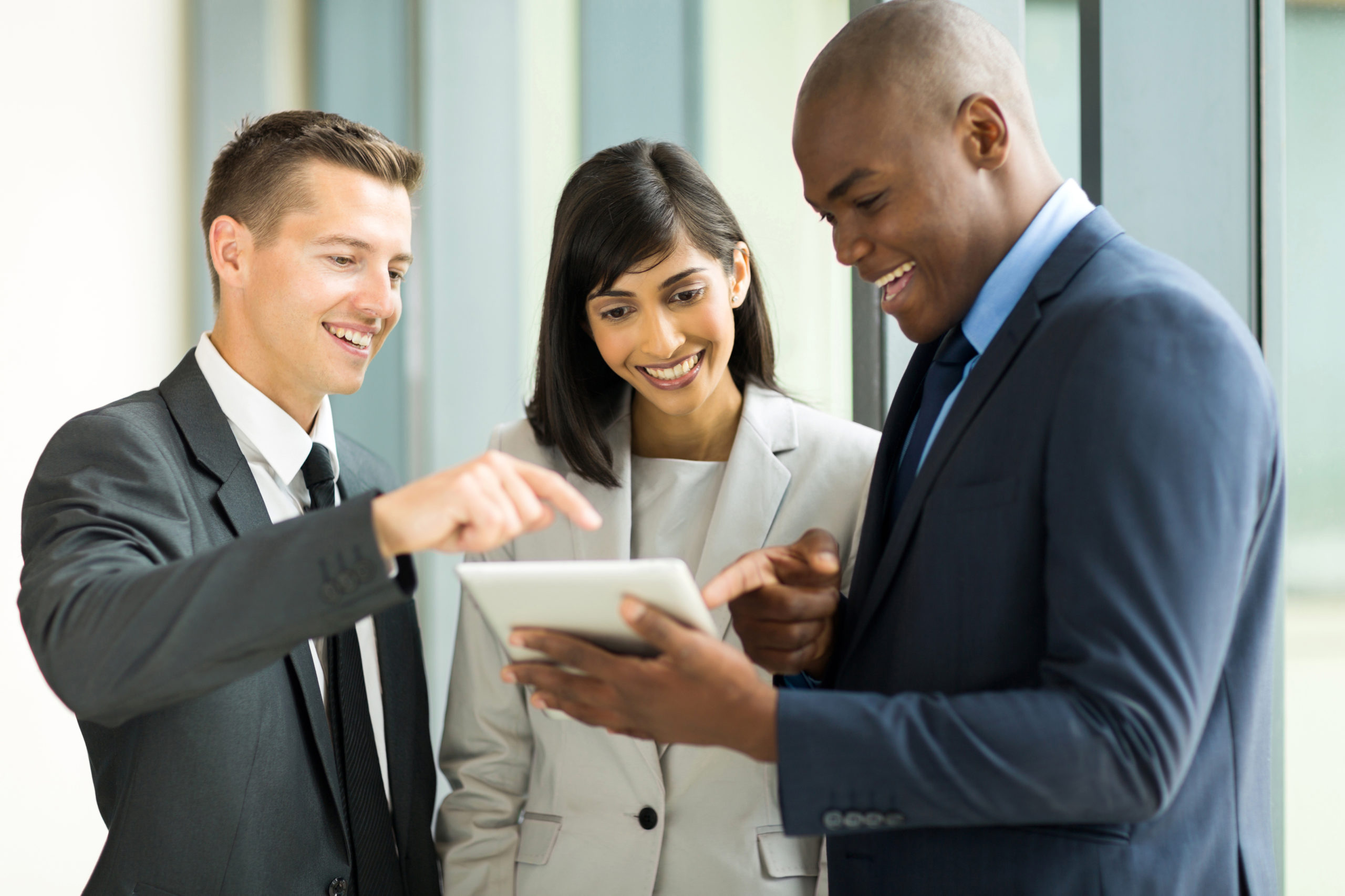 friendly business team using tablet computer in office