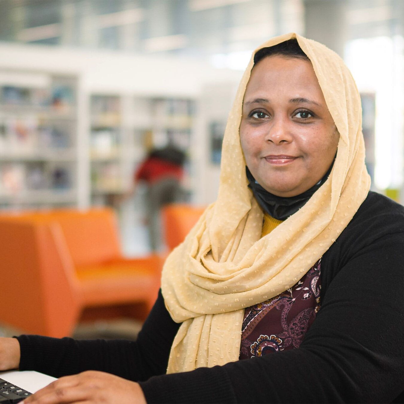 A muslim woman using a computer